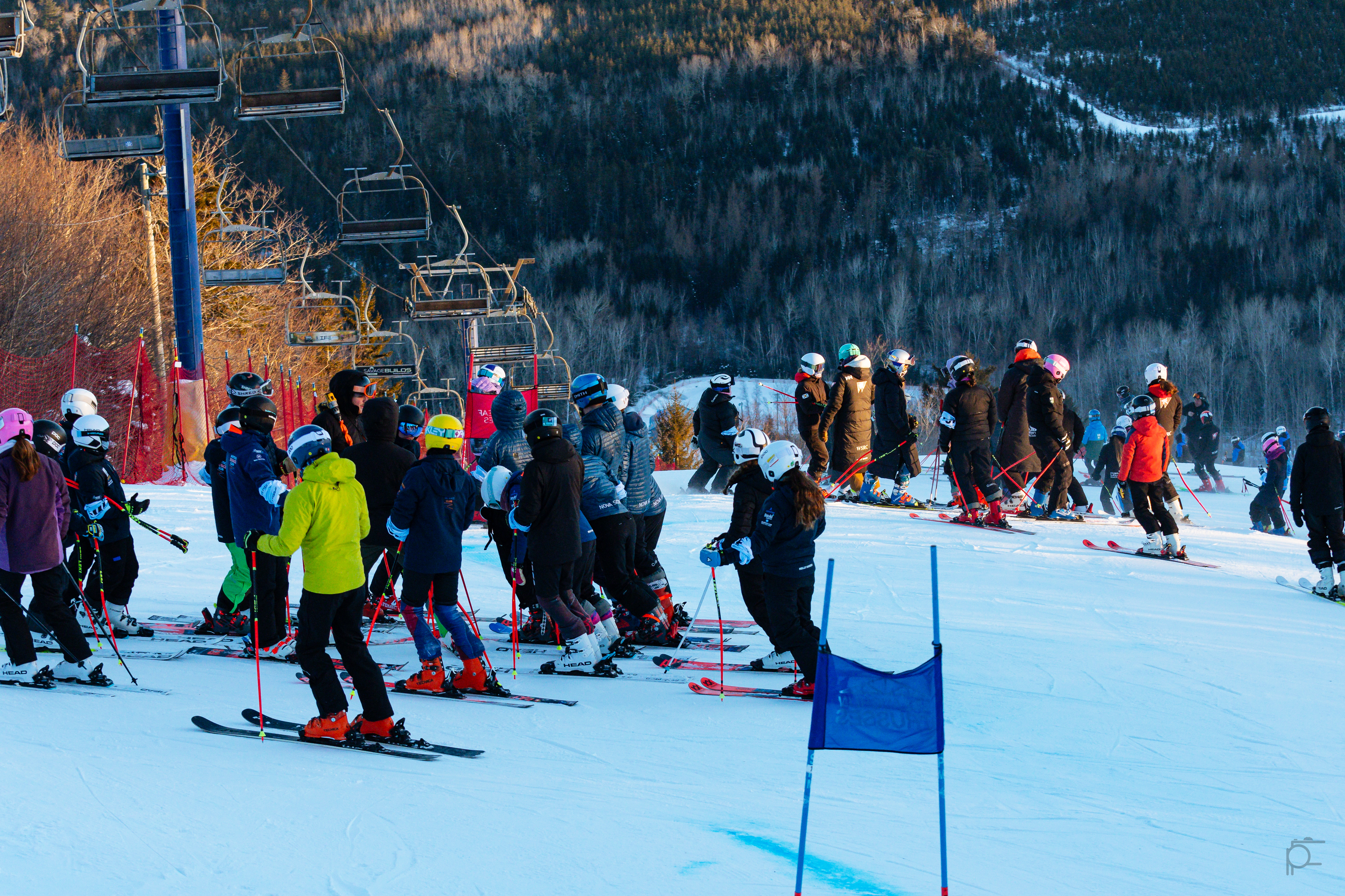 Young athletes and coaches gathered on a ski hill