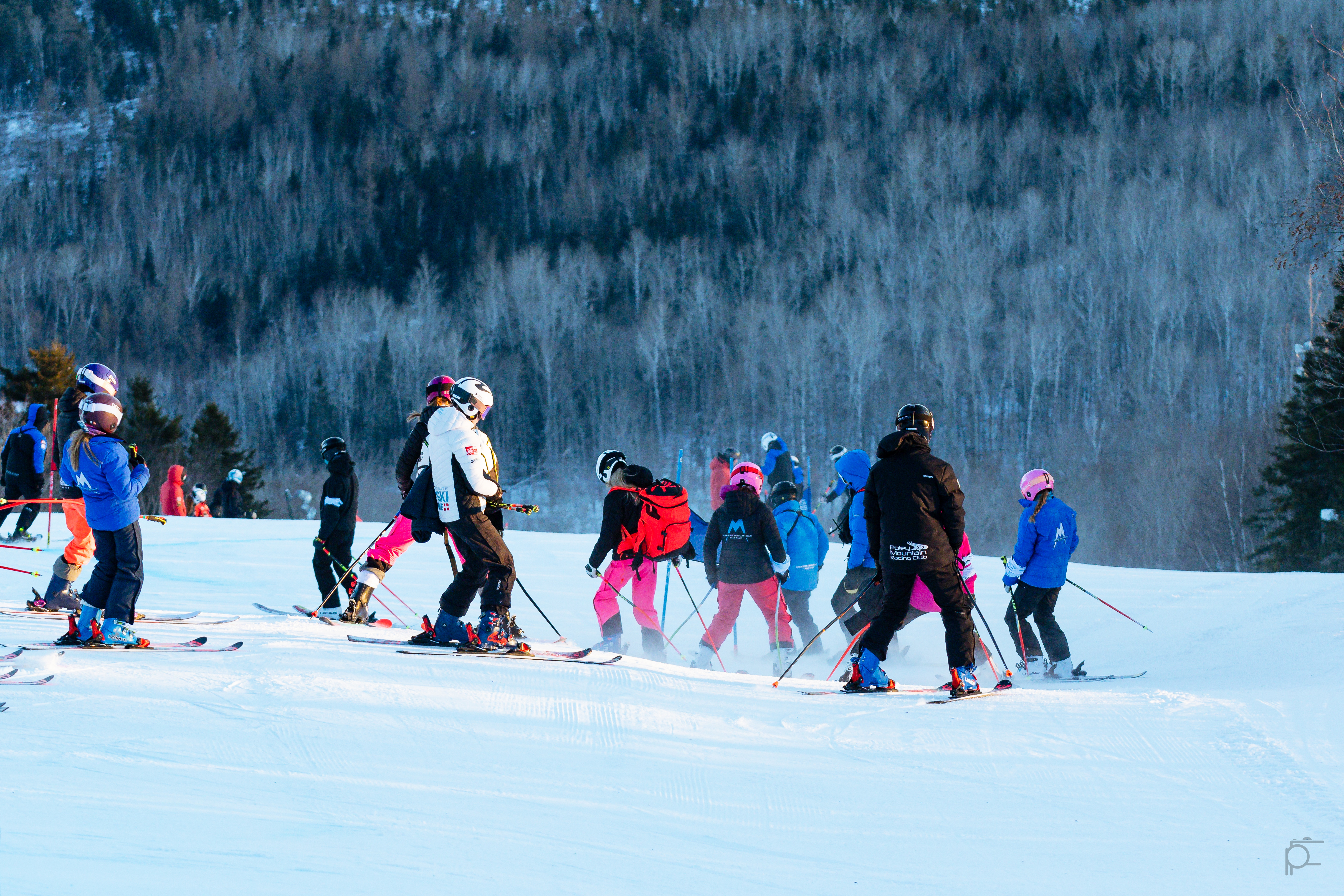 Athletes and coaches inspecting a course on snow
