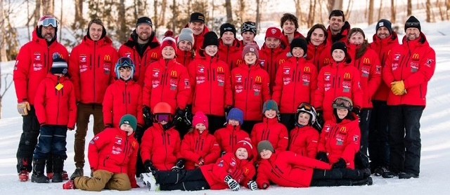 Mont Farlagne Race Team athletes and coaches in red jackets